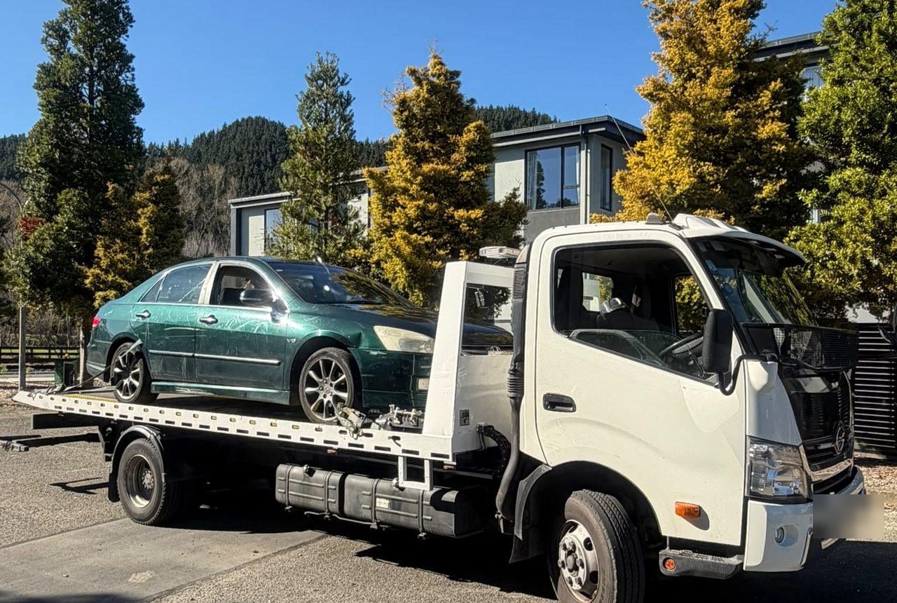 Car Wreckers Rotorua loading a Toyota sedan onto the flatbed for wrecking in the Bay of Plenty